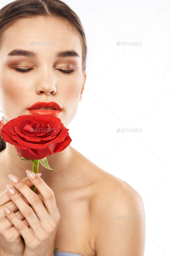 Charming Brunette Girl With Makeup On Her Face And A Red Rose In Her Hand Stock Photo By Shotprime