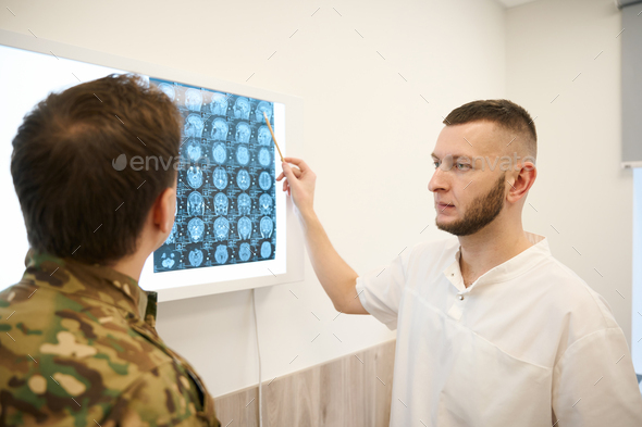 Doctor Interpreting Magnetic Resonance Imaging Results Of Head To