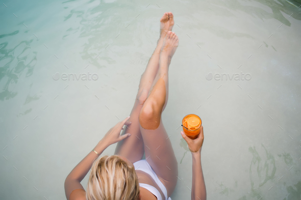 Slim Woman In Bikini Sitting On Sandy Pool Floor Stock Photo By GaudiLab