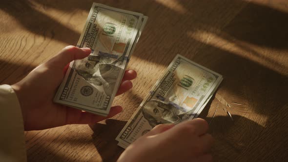 Handheld Close Up Of Caucasian Woman Hands Counting Money In Slow