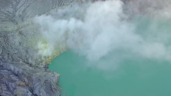 Aerial View Of Rock Cliff At Kawah Ijen Volcano With Turquoise Sulfur