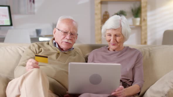 Elderly Couple Shopping Online Together alt