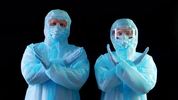 Doctor, Nurse, in Protective Uniforms, Masks, Goggles, Looking at Camera, Showing Stop Gesture By alt
