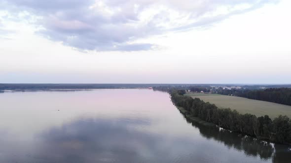A Beautiful Panorama of a Large Lake Taken From a Bird's Eye View on a Summer Day and a Cottage alt