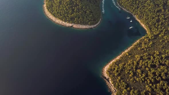 Aerial view of boats anchored at the shore of Krivica, Croatia. alt
