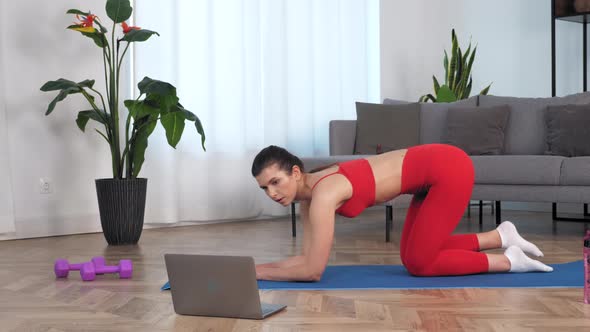 Fit Woman Does Exercise for Buttocks Raises Leg Up on Fitness Mat Study Online alt