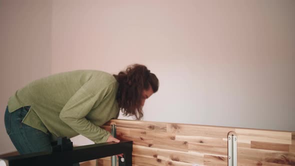 People Lift And Turn Up The Newly Built DIY Table Inside The House. - close up alt