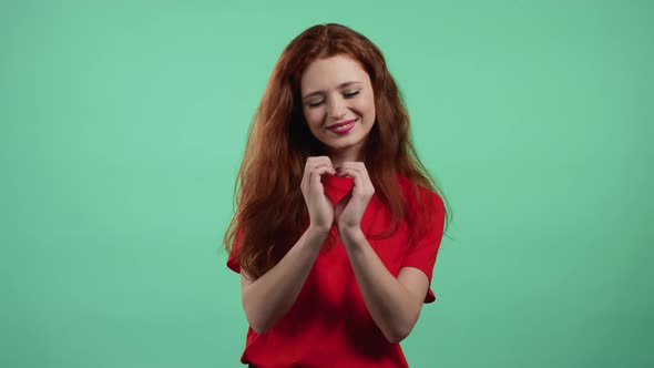Kind Pretty Woman Making Sign of Shape Heart Near Her Chest alt