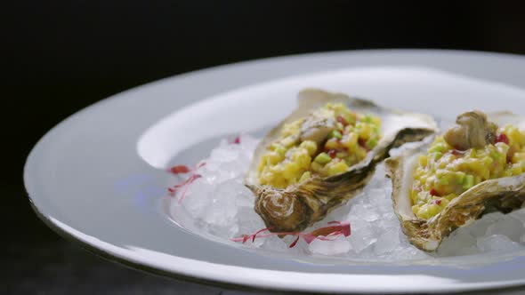Fresh raw open oysters on ice in restaurant