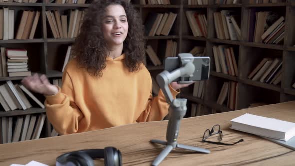 Hispanic Teen Girl Blogger Record Vlog Video Tutorial on Smartphone in Library alt