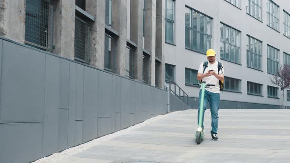 Courier Checking Customer Address on His Phone Food Delivery Outbreak alt