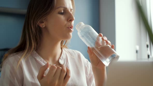 Girl Drinking Water From Glass Bottle