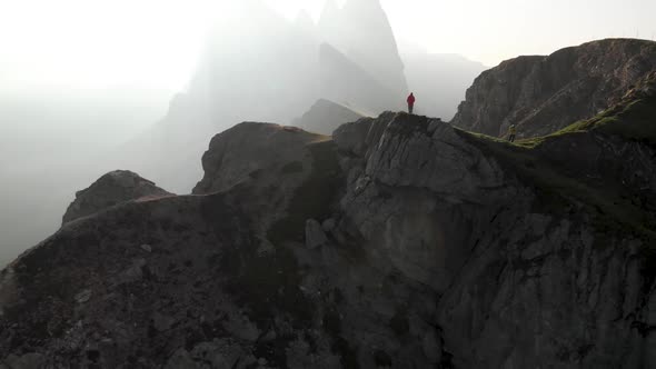 Aerial Unveil Shot of Man Hiker Standing on Top of Seceda Mountain Dolomites Italy