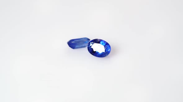 Natural Kyanite Gemstone on the White Background on the Turning Table alt