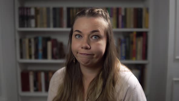 The Woman with Blue Eyes Spreads Hands and Shrug Shoulders Being Perplexed alt