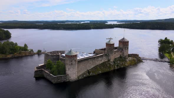 Rotating Aerial Drone Shot of Medieval Castle Olavinlinna (Finland) on a beautiful Summer Day alt