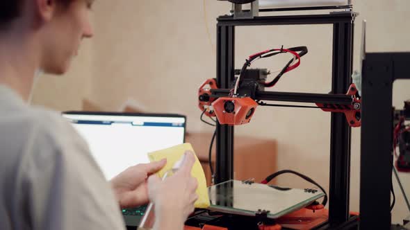 Man Cleaning 3d Printer Before Using