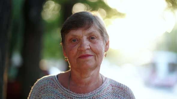 Beautiful Portrait of Smiling Aged Woman on the Summer Street alt