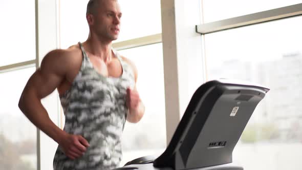 Muscular Athletic Bodybuilder Fitness Model Running Treadmill Gym Near Big Window alt