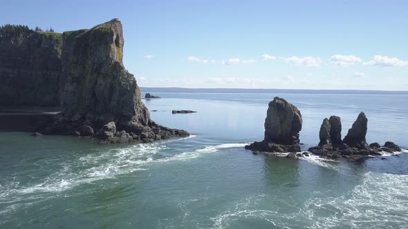 Flying over rushing tidal waters around the rocky outcrops of Cape Split, Nova Scotia. alt