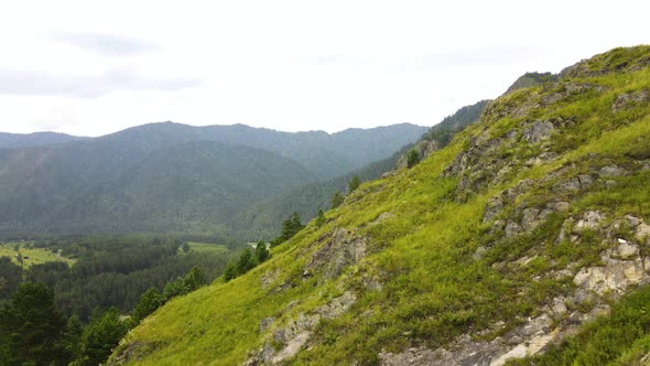 Mountain Range Against the Backdrop of a Summer Landscape with a River alt