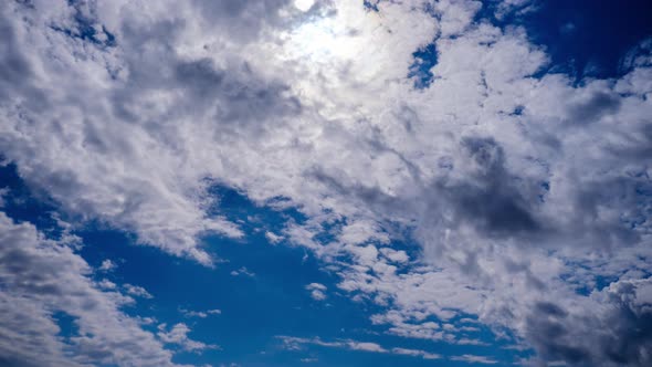 Timelapse of Cumulus Clouds Moving Under the Sun in the Blue Sky Cloud Space alt