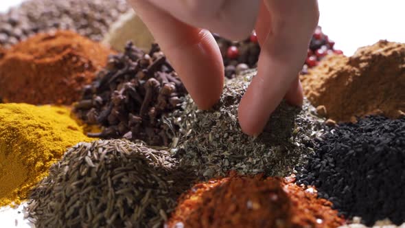 Human Hand Holds and Press a Pinch of a Fragrant Herbs By a Hand Over alt