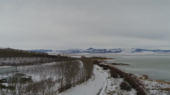 Flying over a farm near the shoreline of Utah Lake near Lincoln Beach, looking toward the west mount alt