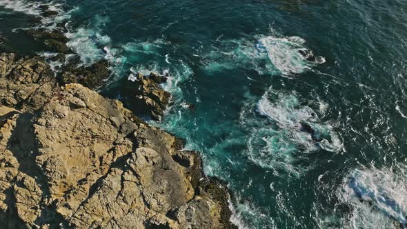 The Pacific Ocean Washes Onto the Rocky Coastline alt