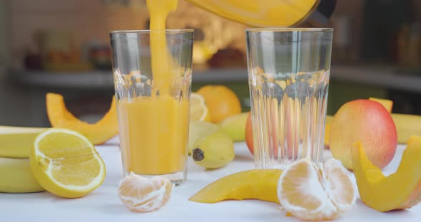 Pouring Organic Freshly Squeezed Fruit Smoothie Into the Glass alt