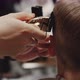 Fashionable Hairdresser Cuts a Child&#39;s Hair with a Clipper in a Barbershop - VideoHive Item for Sale