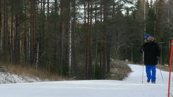 Young Man Does Sport, Fitness, Nordic Walking And Exercising Outdoors, Winter Forest, Countryside.