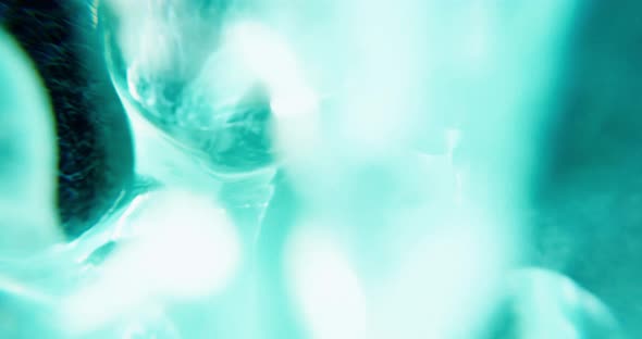 abstract turquoise background with bubbles and particles.