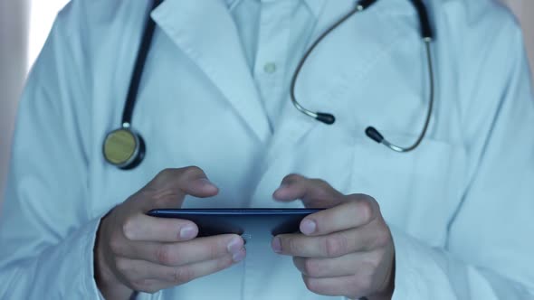 Doctor Playing Mobile Phone