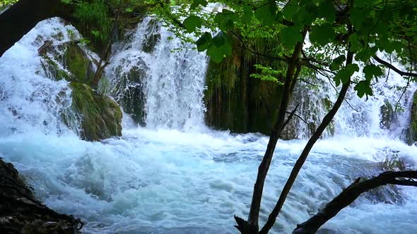 Close up of the base of a waterfall rushing waters in slow motion alt
