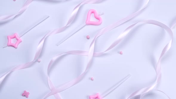 Background with Pink Ribbons Candles and Beads on a White Background the Concept of Celebrating the