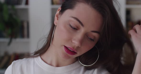 Young Sensual Girl Adjusts Her Long Hair Looking To Camera with Temptation Slow Motion alt