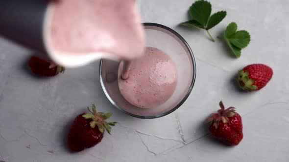 Pouring Strawberry Smoothie with Protein Into Glass