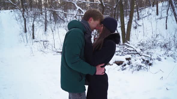 Lovers Stand and Hug in Winter Forest alt