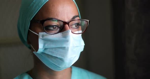 Young female medic, wearing a mask and glasses