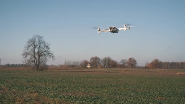 White Drone Hanging in Air or Flying on Nature Background 4K Shot	 alt