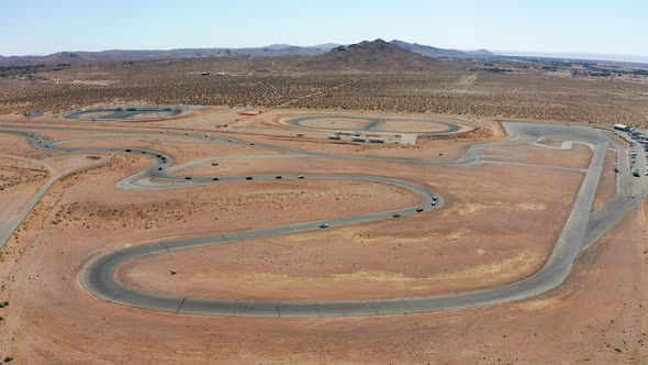 Cars in a competitive race compete for the win - aerial view of the racetrack complex alt