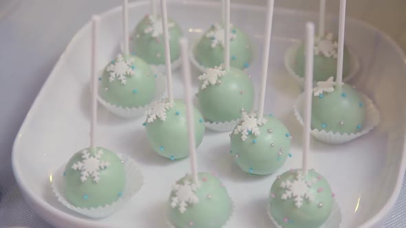 Sweet chocolate dessert icing on a stick in a white plate