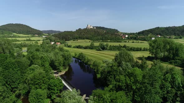 Beautiful Aerial View of the River with a Weir (Mountains and Castle in the Background) - 4K