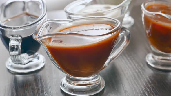 Variety of Sauces  Cream Tomato Soy Sauces Rotating on a Table alt