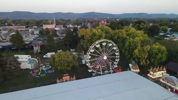 View toward mountains with large intersection. Carnival seen with Ferris wheel and rides.