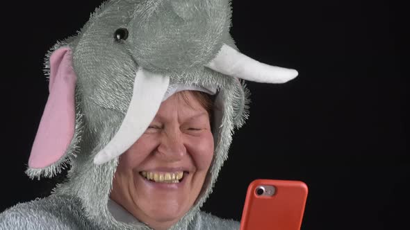 Closeup Shot of a Lady in an Elephant Costume Laughing at Her Phone