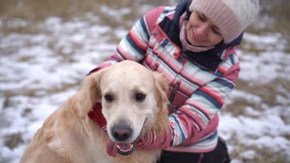 Woman Stroking Dog on Winter Nature alt