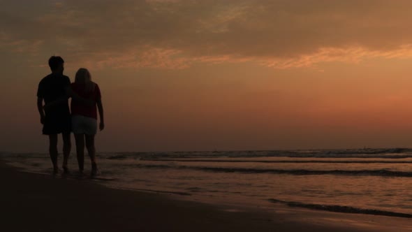 Beach Sunset Couple Walking Romantic on Honeymoon in Love