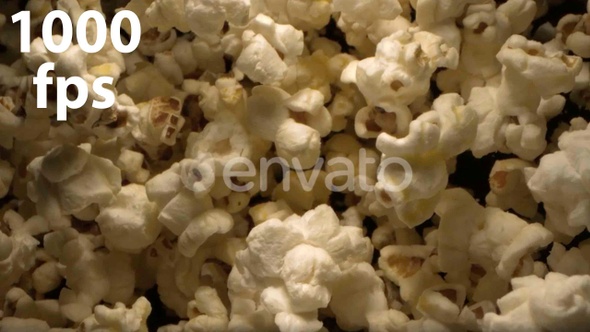 Popcorn Tossed Up In The Air Against Black Background An Overhead Shot 4K alt